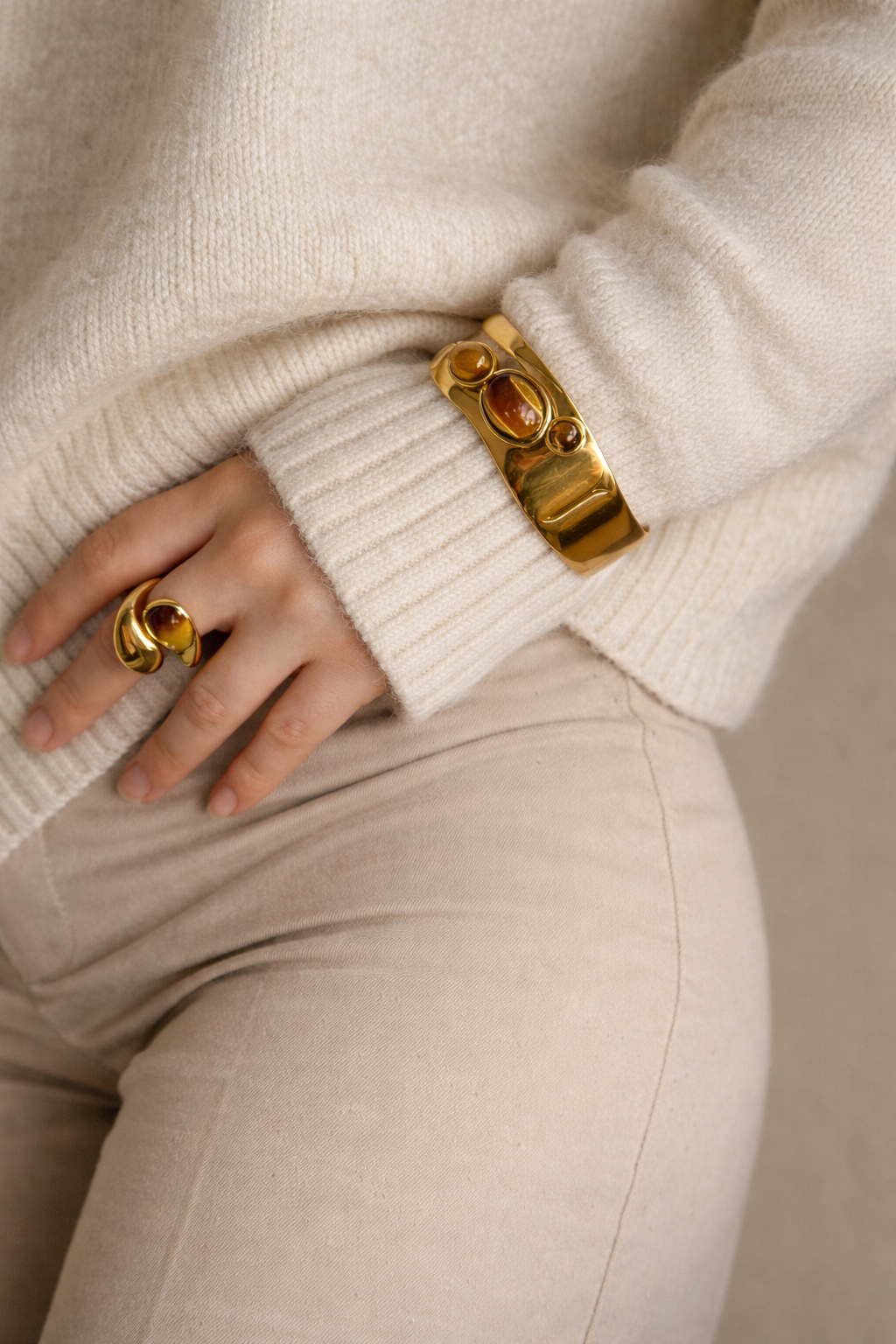 Woman wearing LUMHARA 18K gold plated bracelet and ring with natural stones