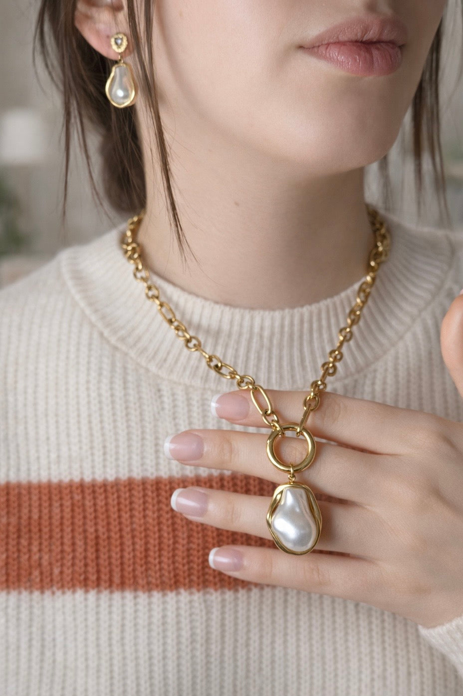 Woman wearing LUMHARA 18K gold plated necklace and earrings with natural pearl stones